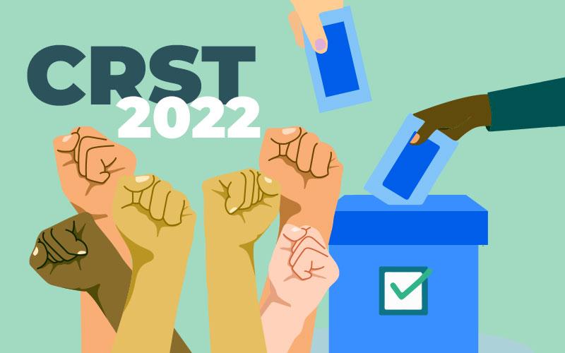 Arte com fundo verde composta por punhos erguidos indicando vitória e luta, uma urna na cor azul com uma mão de pele negra votando, e no canto superior esquerdo, o texto CRST 2022
