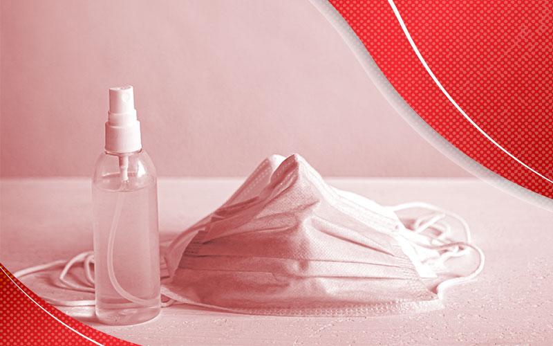 Arte com filtro vermelho mostra uma máscara descartável contra vírus respiratórios e um frasco de alcool