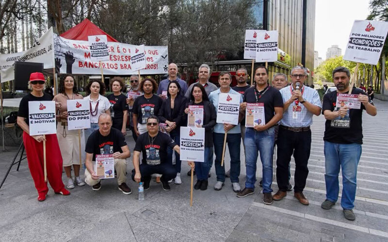 Imagem mostra dirigente sindical welington correa distribuindo material impresso a bancários do santander