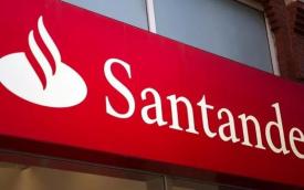 Imagem mostra fachada de agência do Santander, focada na placa onde se vê o nome e o logo do banco