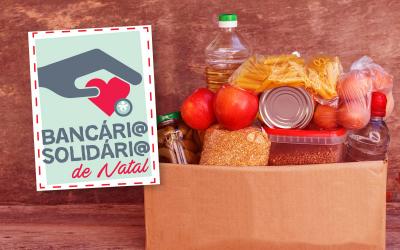 Imagem com o logo da campanha Bancário Solidário de Natal e uma cesta alimentação