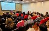 Imagem mostra auditório cheio durante o seminário “NR-1 e a Saúde Mental dos Trabalhadores”.